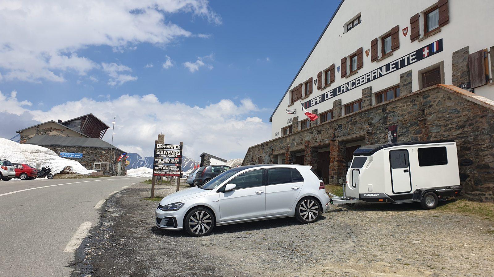 Dashaway parked on Alpine pass with mountain backdrop