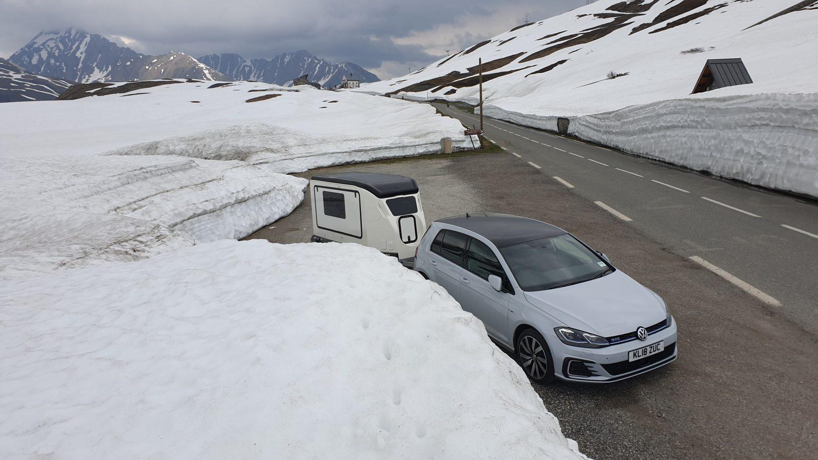 French Alps road winding through pine forest